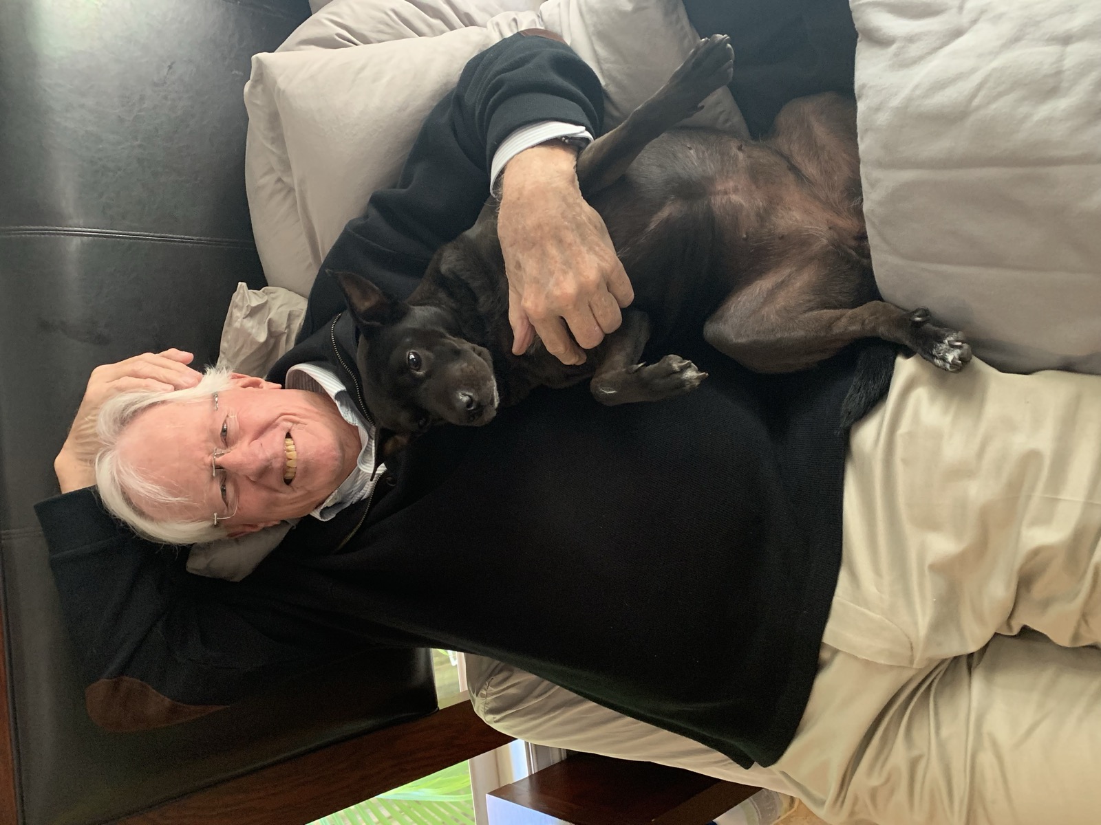John relaxing at home with his dog, Leica